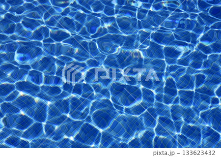 Blue water texture, tiles pool in sunny day 133623432