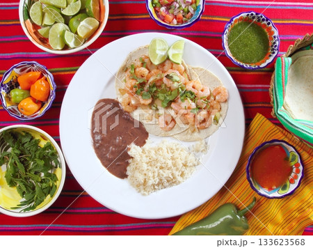 shrimp tacos rice and frijoles chili sauces Mexican 133623568
