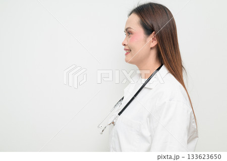 Profile View of Happy Smiling Asian Healthcare Professional Doctor in White Coat Studio Portrait 133623650