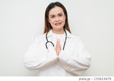 Happy Smiling Thai Healthcare Professional Doctor in White Coat Greeting with Wai Gesture 133623679