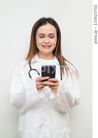 Asian Healthcare Professional Doctor in White Coat Using Mobile Phone Asian Healthcare Professional Doctor in White Coat Using Mobile Phone 133623702