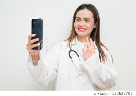 Asian Healthcare Professional Doctor in White Coat Using Mobile Phone Taking Selfie 133623708