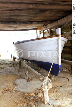 Formentera boat stranded on wooden rails Formentera boat stranded on wooden rails 133624044