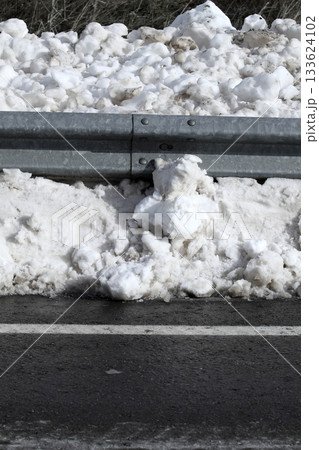 Snow asphalt winter road border steel traffic fence Snow asphalt winter road border steel traffic fence 133624102