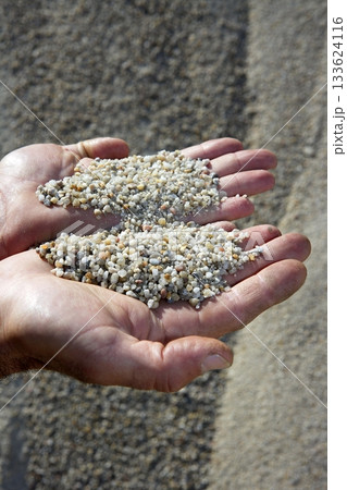 gravel sand in man hands in quarry showing camera 133624116
