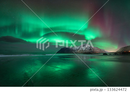 Northern lights over snowy mountains in Lofoten, Norway. Aurora 133624472