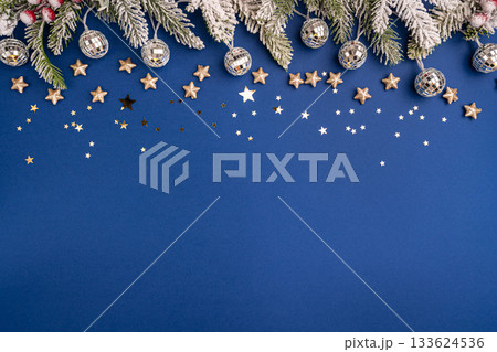 Christmas Lights and Stars with Snowy Pine on Blue Background Christmas Lights and Stars with Snowy Pine on Blue Background 133624536