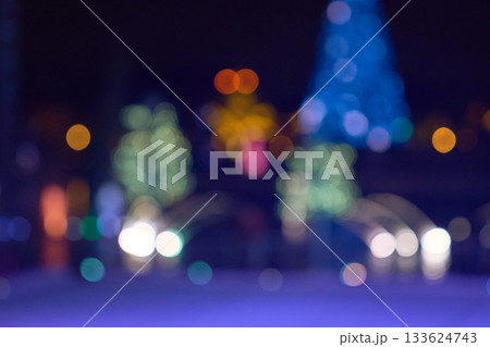 Cool blue and warm golden bokeh dots glow across the frame. The soft, defocused lights create a modern holiday background. 133624743