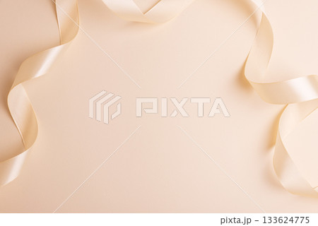 Elegant Satin Ribbon on Beige Background for Festive Design 133624775
