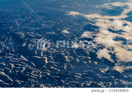 View from airplane to clouds and land 133626963