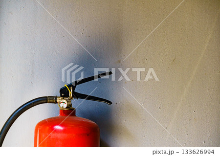 Fire extinguisher agains wall 133626994