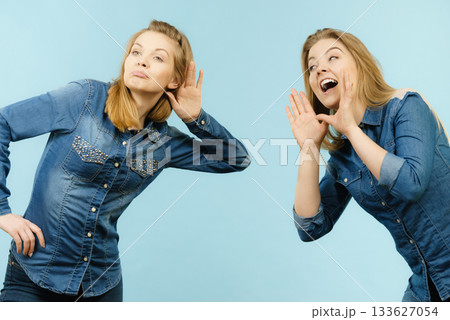Two women telling tales, rumors gossip Two women telling tales, rumors gossip 133627054