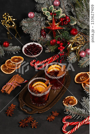 Strong alcoholic or non-alcoholic cocktail, mulled wine with spices, star anise, cranberry, orange, apple and cinnamon, a warming winter drink in the cold season, a Christmas festive grog, 133627409
