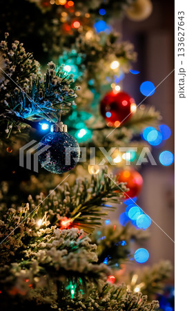 A close up of a Christmas tree decorated with ornaments and lights 133627643