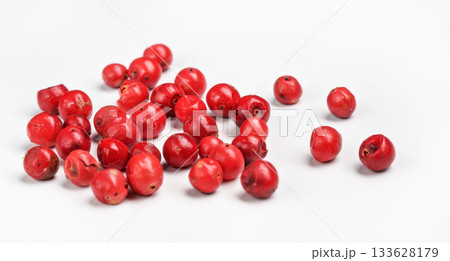 Red or Pink peppercorn scattered on board, closeup photo isolated with white background 133628179
