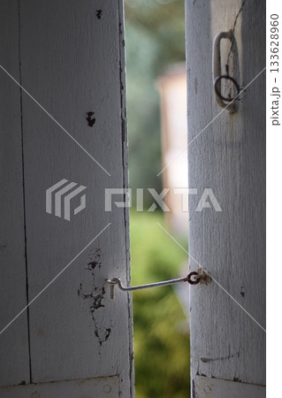 White wooden window opened. View from window to garden. White wooden window opened. View from window to garden. 133628960