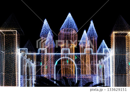 The castle structure is illuminated with blue and white lights from garlands The castle structure is illuminated with blue and white lights from garlands 133629151