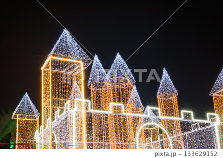 Illuminated castle structure with colorful lights at night 133629152
