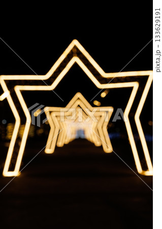Illuminated star-shaped light tunnel at night Illuminated star-shaped light tunnel at night 133629191