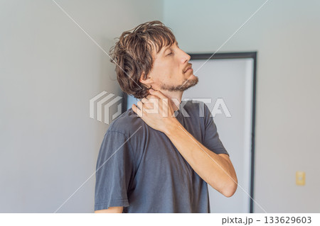 Man holding his neck in discomfort, experiencing tension and pain, concept of muscle strain, posture issues, stress, health awareness and physical well-being Man holding his neck in discomfort, experiencing tension and pain, concept of muscle strain, posture issues, stress, health awareness and physical well-being 133629603