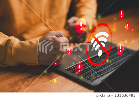 Frustrated user with laptop facing WiFi disconnection, red warning icons and no internet signal error symbol. Concept of network outage, connectivity problem, unstable internet and online frustration. 133630493