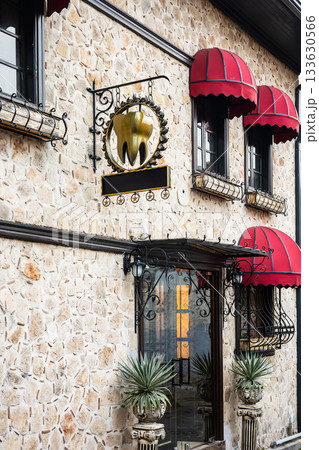 Unique dental office building with stone exterior and red awnings Unique dental office building with stone exterior and red awnings 133630566