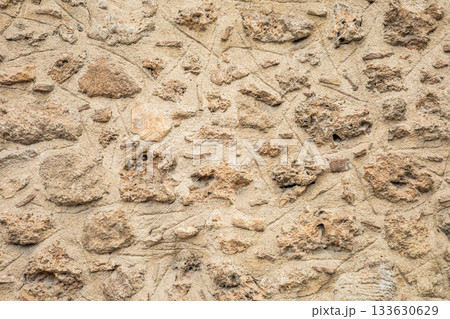 Rough stone wall texture with weathered surface and uneven stones Rough stone wall texture with weathered surface and uneven stones 133630629