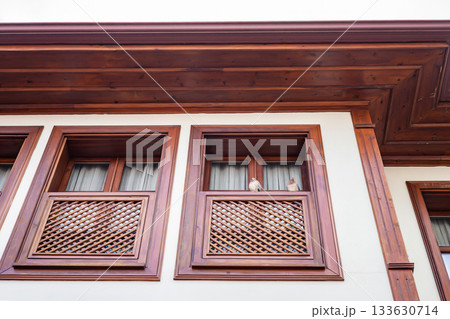 Elderly caucasian couple observing from wooden balcony of traditional building 133630714