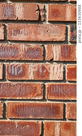 Close-Up Of Red Brick Wall Texture With Weathered Surfaces and Rugged Character 133630988