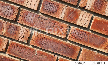 Close-Up Of Red Brick Wall Texture With Weathered Surfaces and Rugged Character 133630991