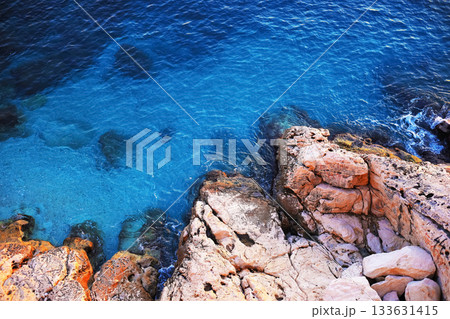 Clear blue waters near rocky coastline Clear blue waters near rocky coastline 133631415