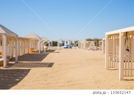 Wooden houses in the sandy desert in a tractor in the form of a trailer 133632147