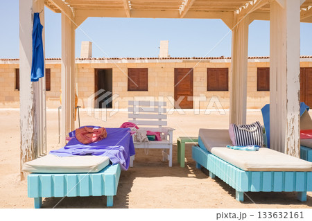 Beach cabana with colorful lounge chairs and towels Beach cabana with colorful lounge chairs and towels 133632161