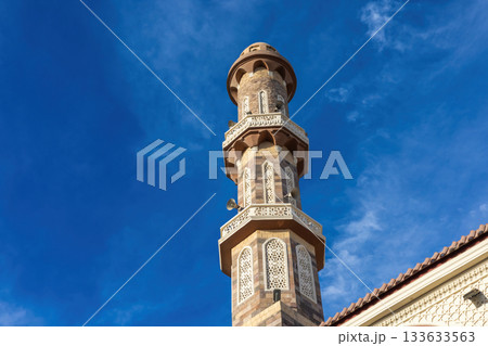 Architectural marvel of an ornate minaret against a clear blue sky Architectural marvel of an ornate minaret against a clear blue sky 133633563