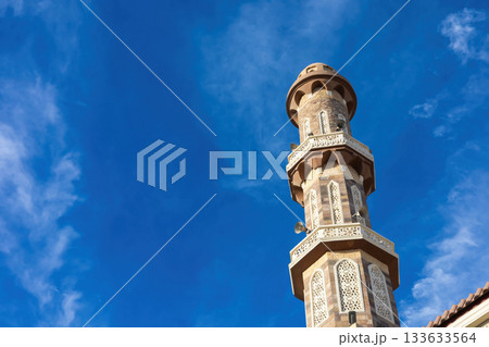 Majestic mosque minaret against vibrant blue sky perfect for travel and architecture inspiration 133633564