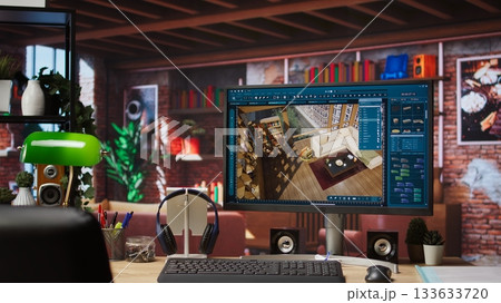 Architectural design software on computer in home office used for moving interior design project assets. CAD software interface on PC display showing home floor plans, jib up shot 133633720