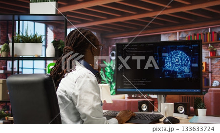 Admin writing code on computer and doing maintenance on artificial intelligence neural networks computerized model. Tech support expert typing on keyboard, doing checkup on AI systems, camera A Admin writing code on computer and doing maintenance on artificial intelligence neural networks computerized model. Tech support expert typing on keyboard, doing checkup on AI systems, camera A 133633724