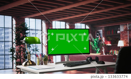 Refined office setup in classy loft with green screen monitor for mockups use. Chic interior design and upscale furniture reflect a serene, creative and exclusive environment. Spacious home. Refined office setup in classy loft with green screen monitor for mockups use. Chic interior design and upscale furniture reflect a serene, creative and exclusive environment. Spacious home. 133633774