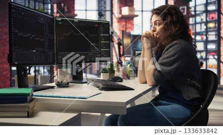 Day trader feeling worried and stressed looking at monetary losses, analyzing stock price trends on pc. Exasperated woman losing shares and dealing with market crash, trading decisions. Camera A. Day trader feeling worried and stressed looking at monetary losses, analyzing stock price trends on pc. Exasperated woman losing shares and dealing with market crash, trading decisions. Camera A. 133633842