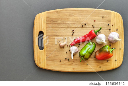 Pepper, chili, and garlic on a wooden surface. Top view. 133636342