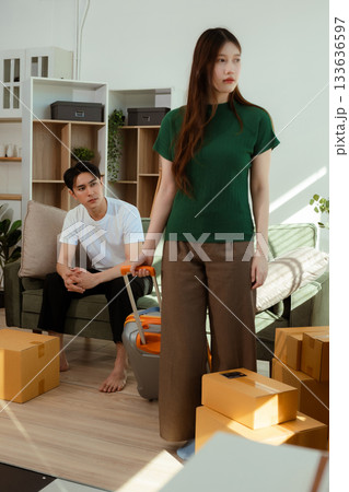 young couple helps put things in boxes and prepares to move to a new house. 133636597