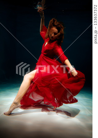 Underwater figure with flowing fabric creates mythic storytelling 133637372