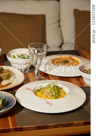 Indulge in Gourmet Dishes Served Within a Modern and Elegant Dining Setting Experience 133637388