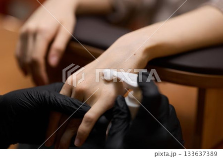 Closeup of professional worker conducting clean nail treatment 133637389