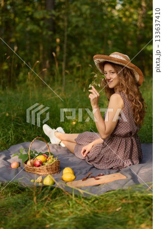 Woman daydreaming outdoors, Picnic lady with floral charm Woman daydreaming outdoors, Picnic lady with floral charm 133637410