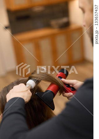 training session for skilled hairdressers focusing on creating volume and shine using authentic styling tools 133637437