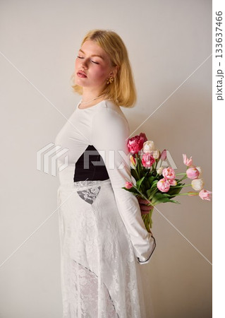 Blonde woman quietly reflective, Caucasian lady with floral 133637466
