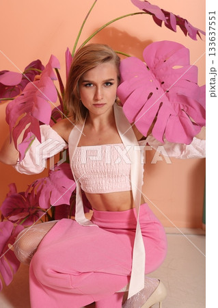Elegant lady surrounded by vibrant pastel tropical leaves Elegant lady surrounded by vibrant pastel tropical leaves 133637551