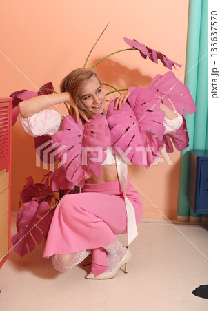 Person holding bright leaves in colorful studio environment 133637570