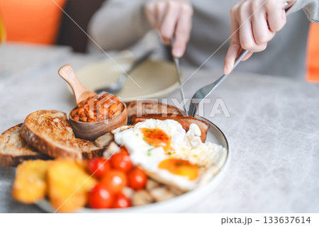 English breakfast menu fried eggs in grilled tomato and bacon sausage plate traditional tasty meal 133637614